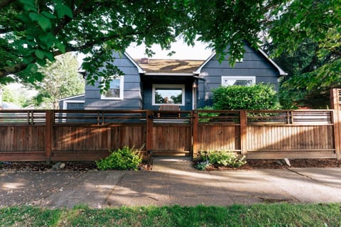 Private front yard with welcoming entry and a beautifully crafted cedar fence.