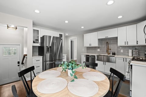 Stylish and fully equipped kitchen featuring sleek finishes, ample counter space, and a cozy dining setup for memorable meals.