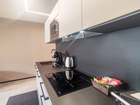 Kitchen, Countertop, Interior Design, Cabinetry, Kitchen Appliance, Flooring, Kitchen Stove, Major Appliance, Furniture, Lighting