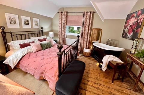 The pink room has a small but perfectly formed roll tap bath, robes and plenty of warm fluffy towels