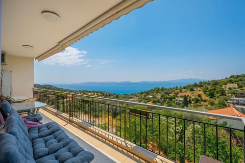 Unwind on your private balcony overlooking lush hills