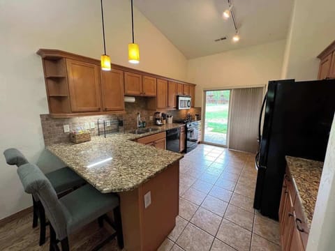 Large gourmet kitchen with gas stove and cooking supplies.