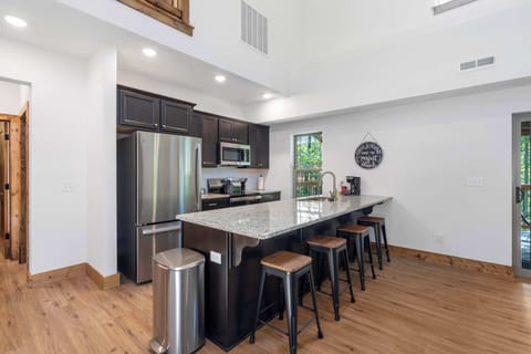 The chic, open kitchen offers ample space & every home comfort