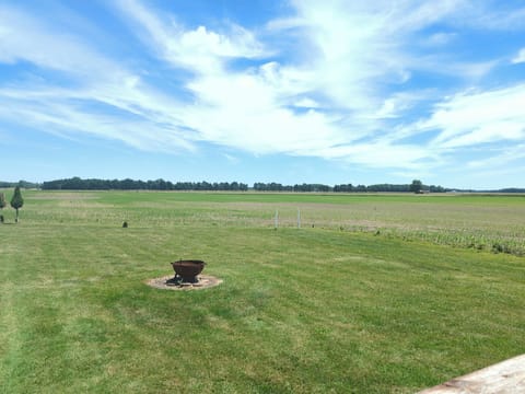 Fire pit in the backyard, shared with downstairs guests. Fields behind the house.