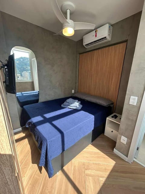 Accent lighting behind the bed, ceiling fan, new A/C, night stand for storage,  and luggage storage beneath the bed.