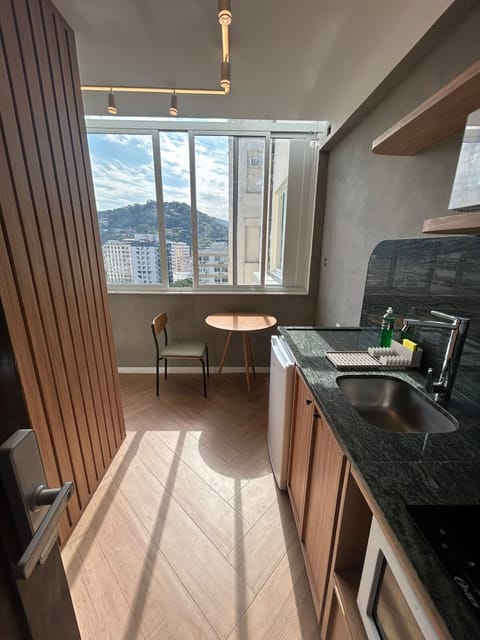 Entrance View. Kitchen fully stocked with cooking & eating utensils. The kitchen also includes a coffee maker & a full set of pots & pans. Table, chair and bench seat, dining for 2. Free view to Laranjeiras hillside.