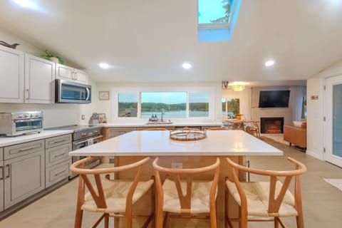 Fully stocked kitchen and kitchen island comfortably seat 6