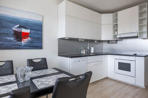 Dining table for four sits adjacent to the open kitchen.