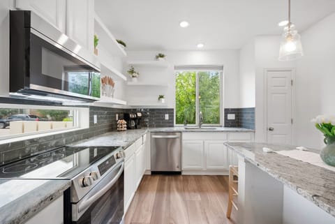 Modern, bright kitchen with stainless steel and granite. Book your stay!