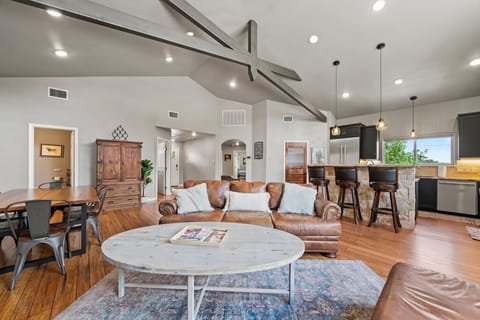 Gather around in this spacious living room, where a sleek leather sofa and glowing indoor fireplace create the perfect spot for movie nights, board games, or simply kicking back with a glass of wine.