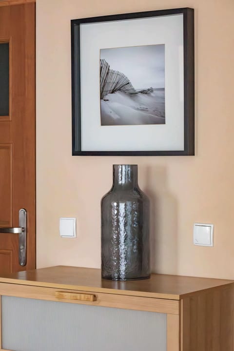 Close-up of the decorative vase that sits on the cabinet.