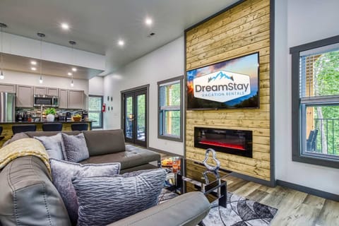 Relax in the spacious living area featuring a large leather sectional and open flow to the kitchen.