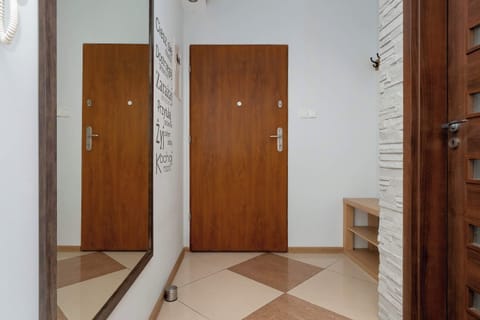 A spacious hallway with a large mirror and closet offers comfort right from the entrance.