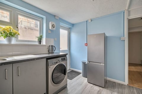 Rear kitchen view showing fridge and back access