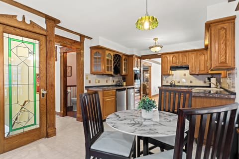 Start your morning in this cozy breakfast nook surrounded by vintage charm and warm natural light.