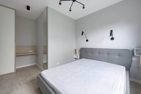 A spacious bedroom featuring a comfortable double bed and minimalist decor.