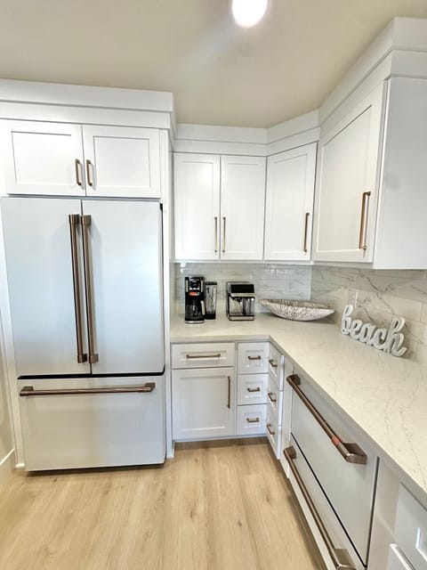New, modern kitchen with Cafe' matte white appliances