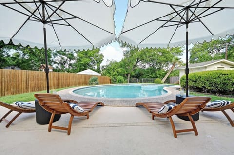 Fully fenced, resort-style backyard featuring a large private pool
