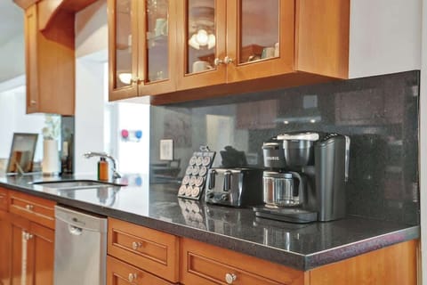 Spacious kitchen with glass cabinets and elegant finishes—ready for cooking and conversation. | Family Airbnb with full kitchen.
