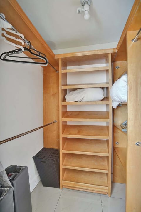  Walk-in closet with shelves, hangers, and storage—stay organized throughout your stay. | Airbnb with ample storage.