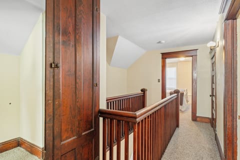 Stairwell overlooking a bedroom, creating an open and airy feel.