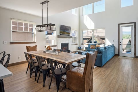 - Open concept dining and living space with tall windows and natural light - Rustic dining table and plush seating make hosting dinners effortless - Stylish fireplace and vaulted ceilings complete this warm gathering space