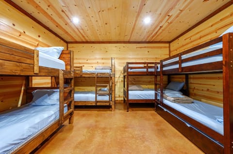 The 2nd bedroom offers a queen bed, 4 twin-over-twin bunkbeds, a twin trundle, & smart TV