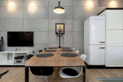 A wooden dining table surrounded by modern chairs. Perfect for shared meals or casual conversations.