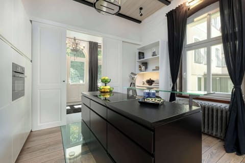 A sleek kitchen island with a stone countertop and built-in storage. Doubles as a breakfast bar.