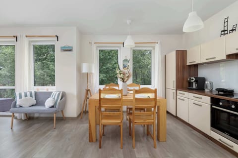 The dining area surrounded by windows invites you to enjoy meals with a view of the greenery.