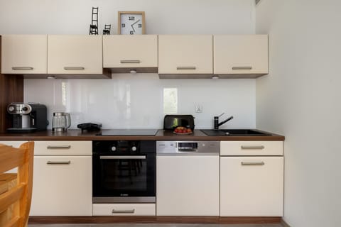 The fully equipped kitchen makes it easy to prepare home-cooked meals during your stay.