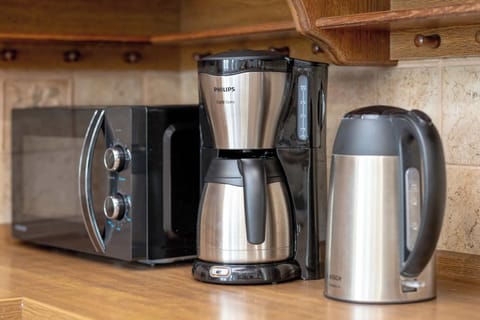 A corner with a coffee maker, electric kettle, and toaster. Perfect for morning routines.