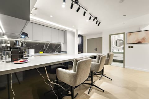 Chic Kitchen: Sleek design with stylish bar stools, perfect for culinary adventures!