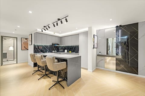 Modern Kitchen: Sleek design, stylish bar stools, and top-notch appliances await your culinary adventures!