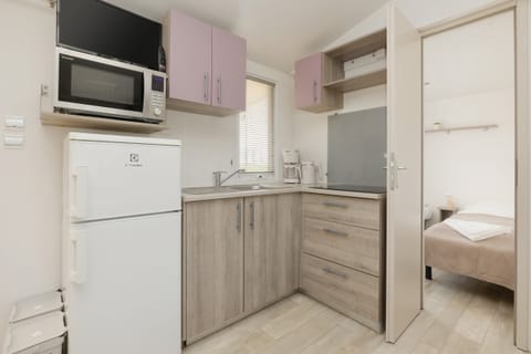 A cozy seating arrangement with a sofa, coffee table, and a view of the open-plan kitchen.