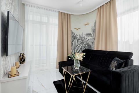 Living room with a comfortable sofa and TV. 