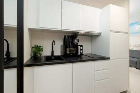 The sleek white kitchen cabinetry balances style and function, making cooking easy and enjoyable.