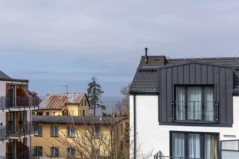 The balcony overlooking the sea and modern buildings is the perfect spot to unwind in the fresh air.