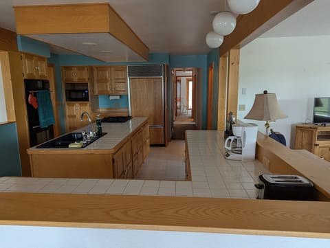 Spacious Kitchen, coffee pot, toaster, fully equipped: pots, pans, and dishes.