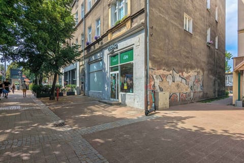 The front of the building with street-level shops and easy access to local amenities.