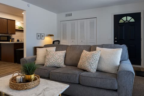 Spacious living area with plush seating and easy access to the kitchen.