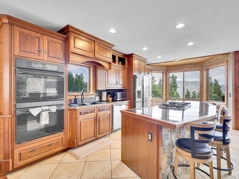 Fully stocked kitchen and dining space — perfect for family meals or chef-prepared dinners.