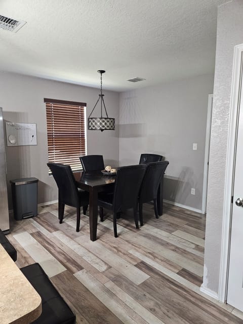The dining area, next to the kitchen, seats 9 guests including bar stools.