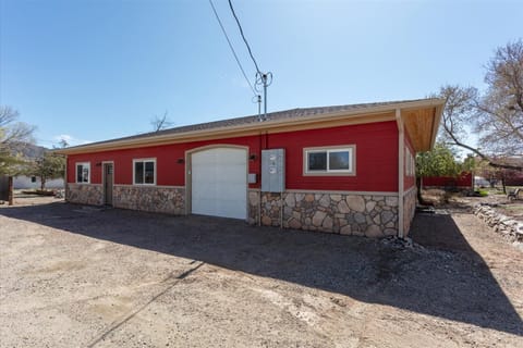 Alley view of exterior (front of cottage), entrance to the left.
