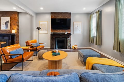 Cozy living room with fire place, TV, and plush couches