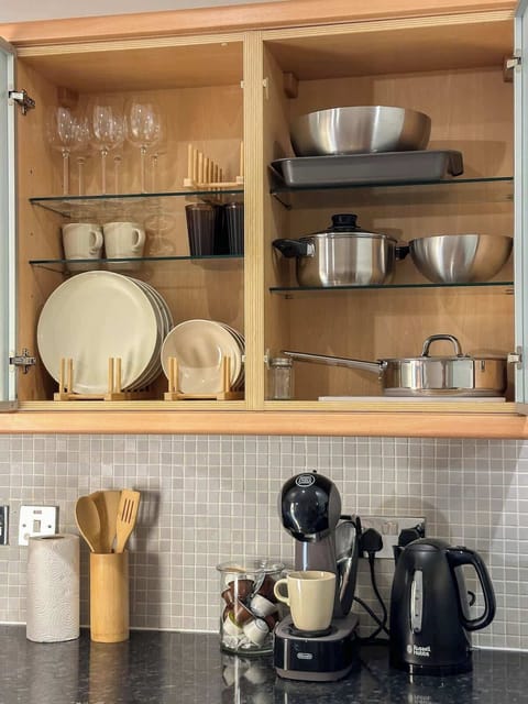 A fully equipped cooking space with modern appliances, ample storage, and countertops for meal preparation.
Kitchen equipment including utensils, kitchen towels, kettle, plates, glasses etc.