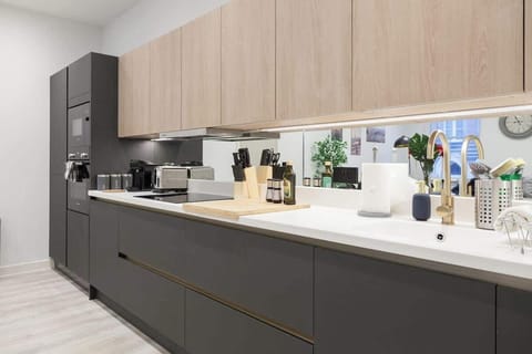 A kitchen is equipped with essential appliances and fixtures for cooking, preparing, and storing food.