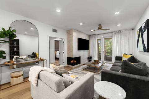 Open living space with cozy fireplace and wall-mounted smart TV