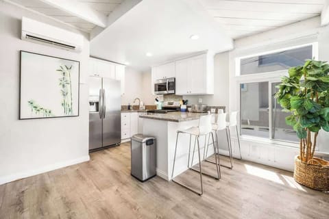 Open kitchen with great natural light and stocked with all of the cooking essentials.