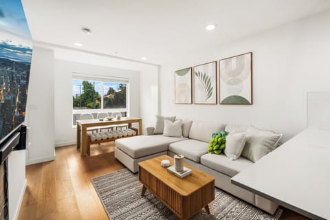 Open floor living and dining room along with a 65" Samsung smart TV